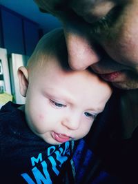 Close-up of father with baby at home