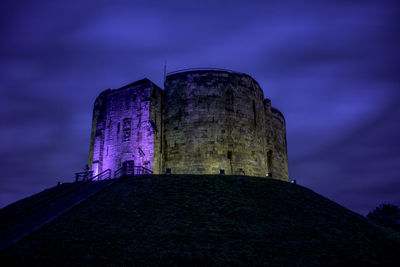 Low angle view of historic building against sky at night