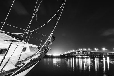 View of illuminated boats moored at night