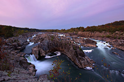 Scenic view of waterfall against sky