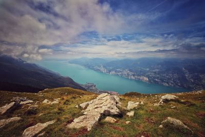 Scenic view of lake by mountains against sky