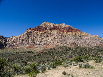 Scenic view of rocky mountains against clear blue sky