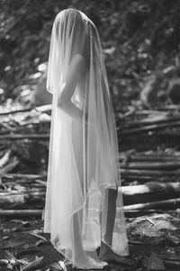 Rear view of woman standing in tent
