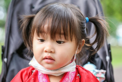 Close-up portrait of cute girl looking away