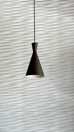 Close-up of electric lamp hanging on metal