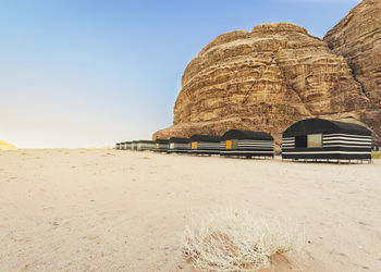 Rock formations on beach against clear sky