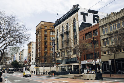 City street by buildings against sky