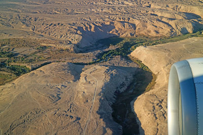 High angle view of airplane flying over land