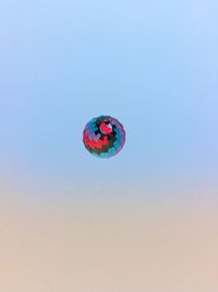 Low angle view of hot air balloon flying against sky