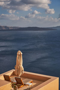 Rear view of woman looking at sea against sky