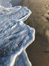 High angle view of surf on beach