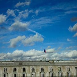 Low angle view of building against cloudy sky