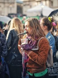 Group of people holding ice cream in city