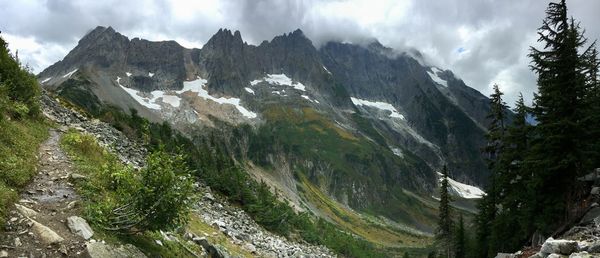 Scenic view of mountains against cloudy sky