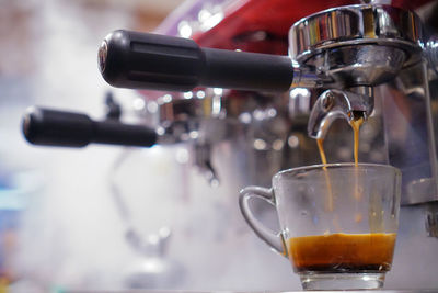 Close-up of pouring coffee in cup