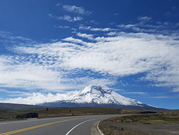 Road by mountain against sky