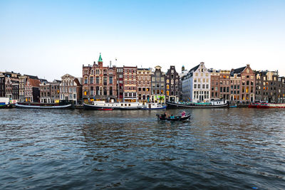 Boats in river in city