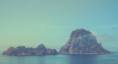 Panoramic view of sea and mountain against clear sky