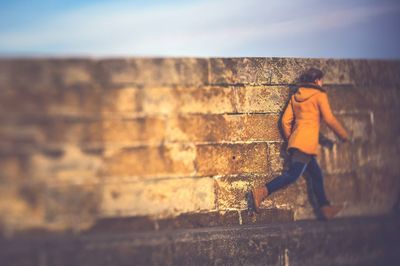 Close-up of running person against the wall