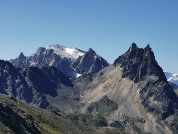 Scenic view of snowcapped mountains against clear blue sky