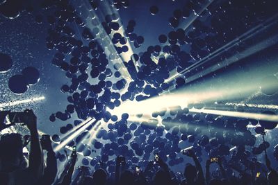 Crowd with helium balloons enjoying at music concert