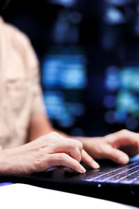 Midsection of woman using laptop