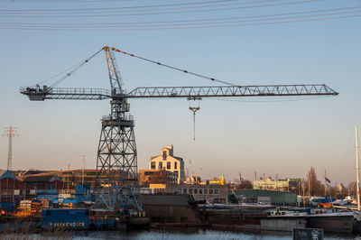 Cranes at construction site against sky