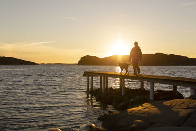 Person with dog on jetty