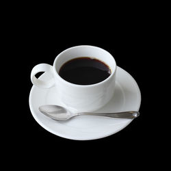 High angle view of coffee cup against black background