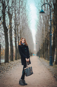 Full length portrait of smiling young woman