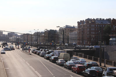 Traffic on road in city against sky