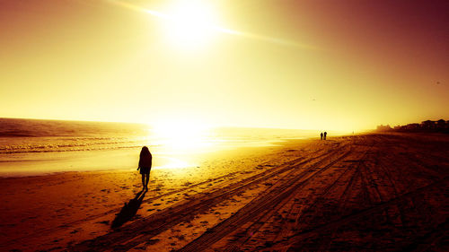 People on beach at sunset