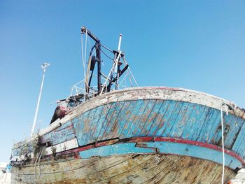 Low angle view of boat against clear blue sky