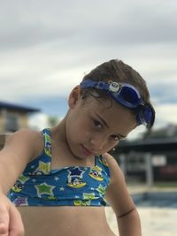 Cute girl wearing swimwear on poolside