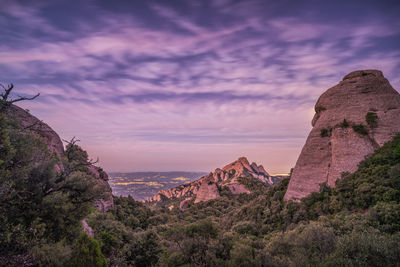 Panoramic view of rock formation against sky during sunset