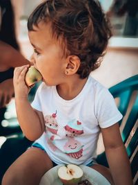 Midsection of girl eating apple