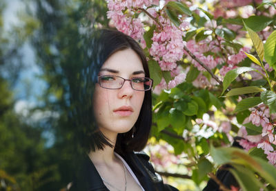 Portrait of beautiful woman against plants