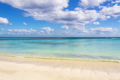 White sand beach and waves on the coast of the caribbean sea, mexico.