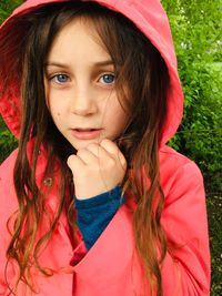 Portrait of cute girl wearing pink raincoat