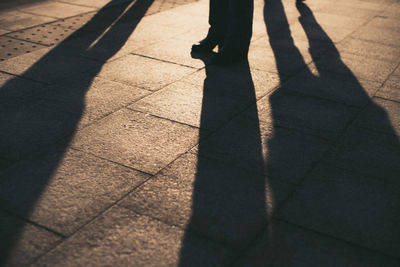 Low section of man standing on footpath