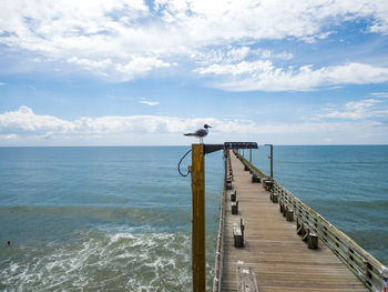 Pier over sea against sky