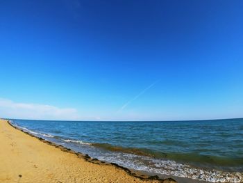 Scenic view of sea against clear blue sky