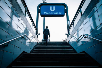 Low angle view of man walking on staircase