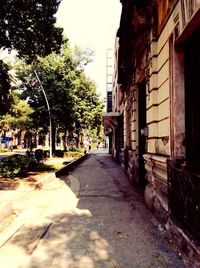 Empty road along buildings