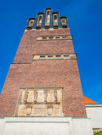 Low angle view of old building against blue sky