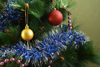 Close-up of christmas decorations hanging on tree