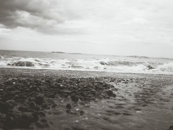 Scenic view of sea against cloudy sky