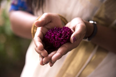 Close-up of woman in sari holding flower