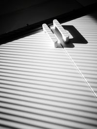 Close-up of hand on tiled floor against wall