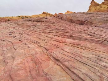 Low angle view of a huge slanted slab of pink stone